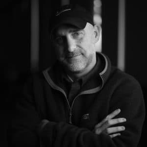 Portrait of Mike Roy with his arms folded.