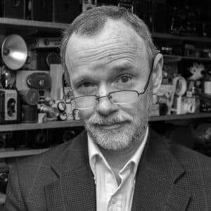 Portrait of David Sutherland with cameras in the background