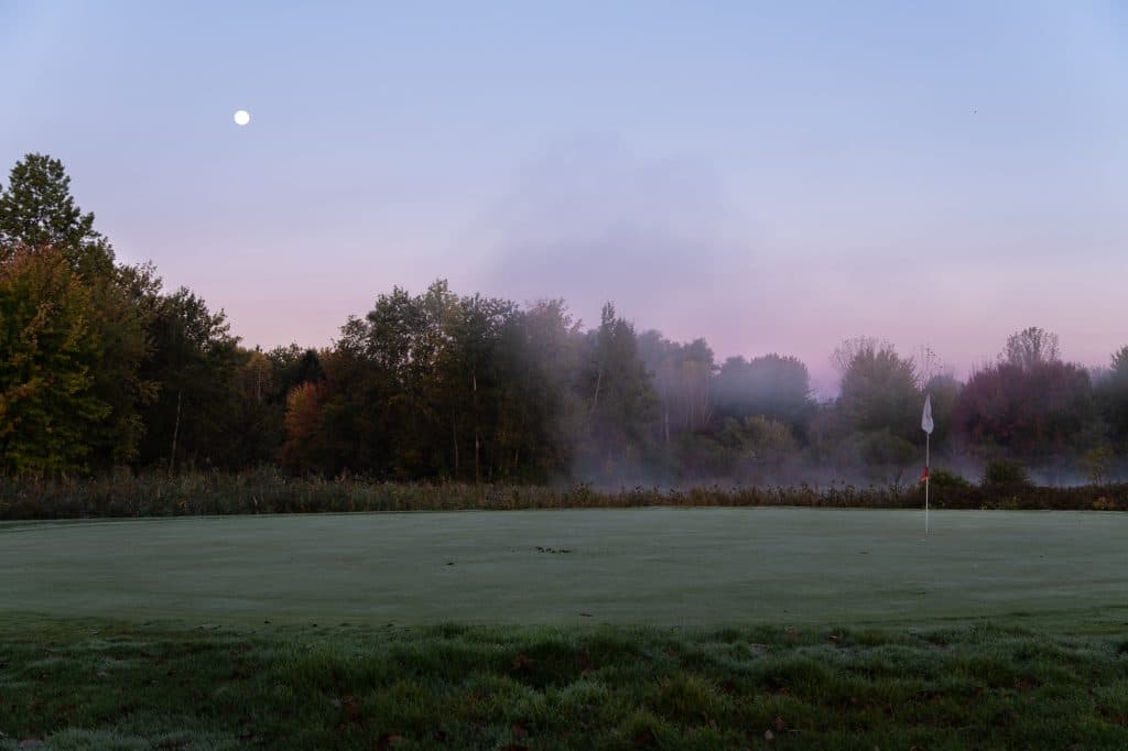 The moon sets as fog rises over the eighth green at Hickory Hill Golf Course. Known as the centerpiece of the course, the eighth green is where many make or break their rounds. Baldwinsville, New York. (Photo by Troy Conner)