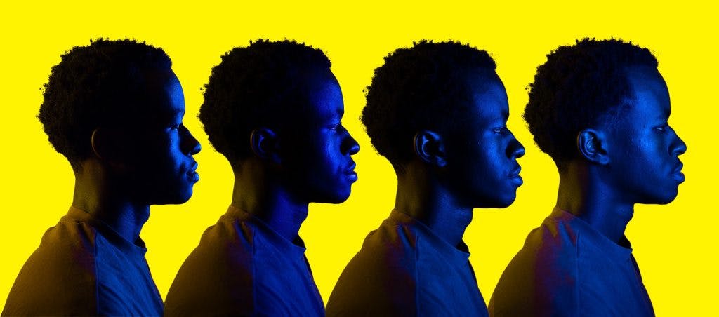 Patrick Tuyishime in profile. The angle of the light differs with each shot for a closer look at how light can change a person's appearance.